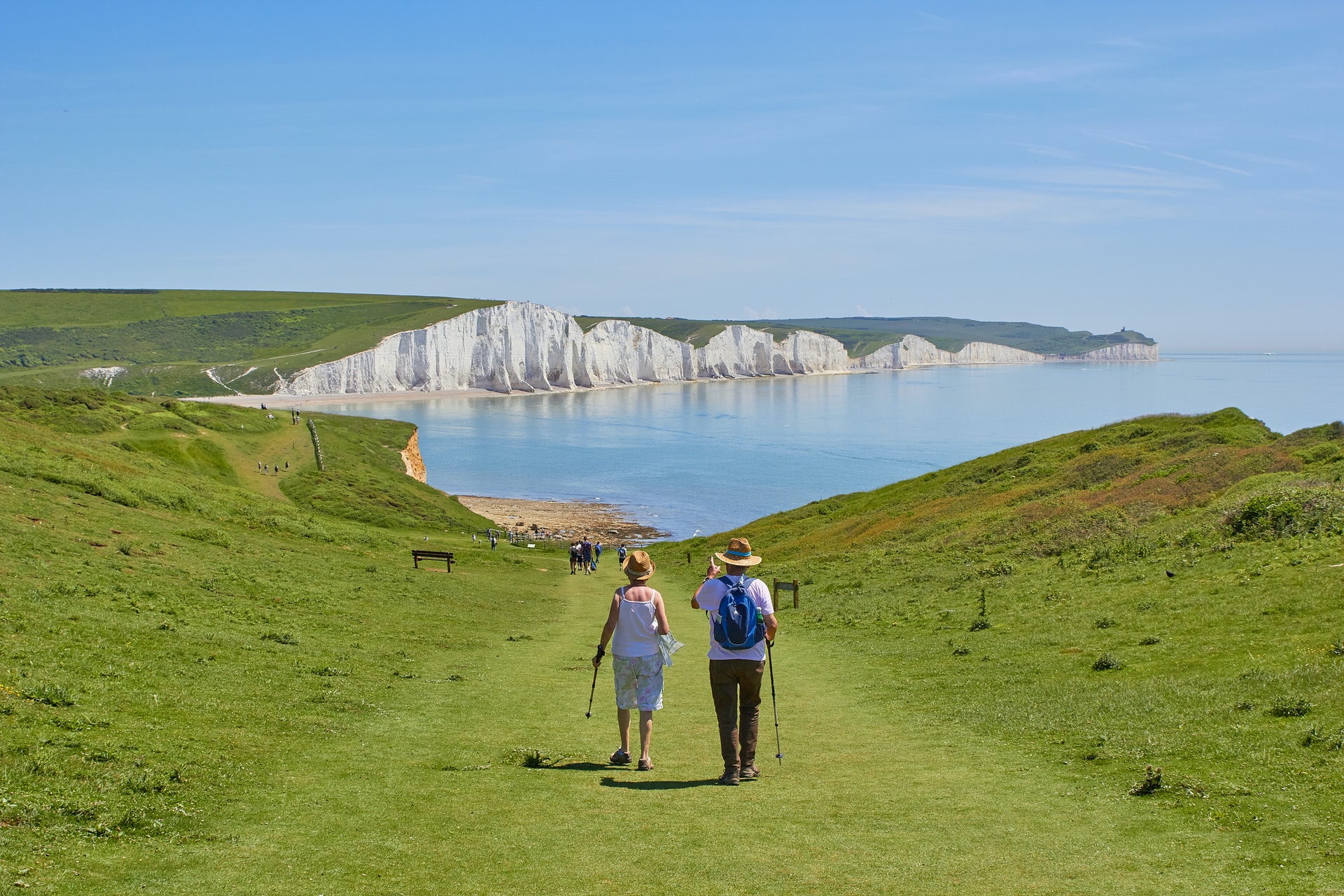 A couple of retirees walking in the outdoors.