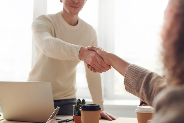 A man and a woman shaking hands